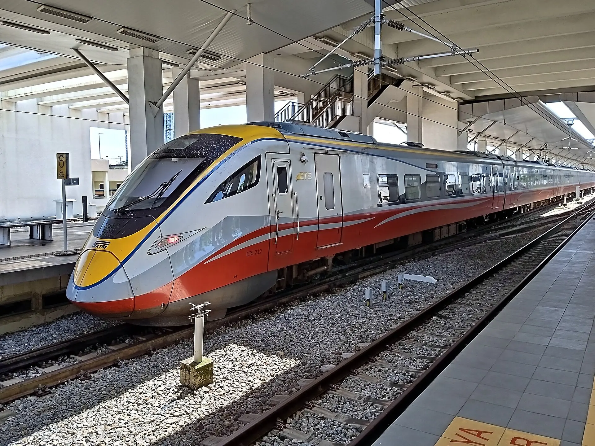 A KTM ETS Class 93 electric intercity train standing at a station platform in Malaysia